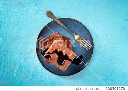 Chocolate brownie with syrup sauce, simple coffee cake, overhead flat lay shot Chocolate brownie with syrup sauce, simple coffee cake, overhead flat lay shot 108501270