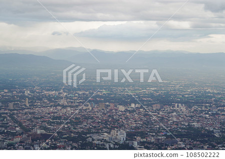 Top view of mountain in Chiang Mai City, Thailand. White cloud and dust is above of the mountain while cities can be seen far away. 108502222
