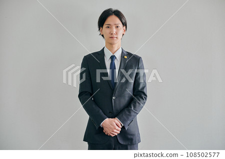 A male lawyer standing against a white background A male lawyer standing against a white background 108502577