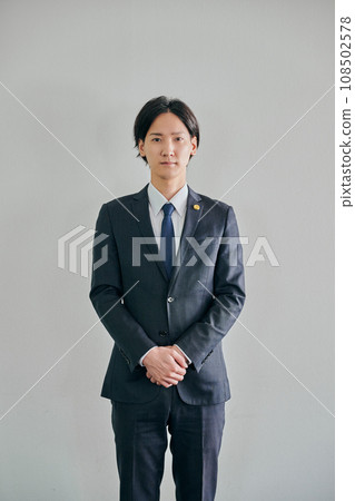A male lawyer standing against a white background 108502578