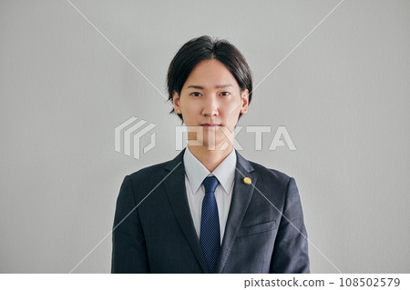 A male lawyer standing against a white background 108502579