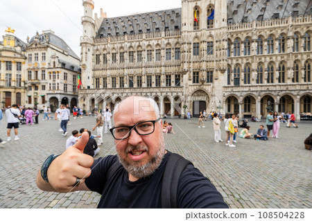Cheerful Tourist's Thumbs-Up Selfie: Exploring Brussels' Heart 108504228