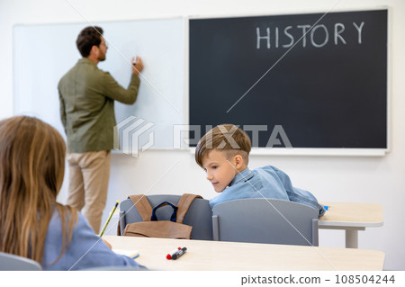 Kids at school sitting at the lesson and looking involved 108504244