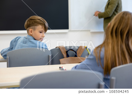Kids at school sitting at the lesson and looking involved 108504245