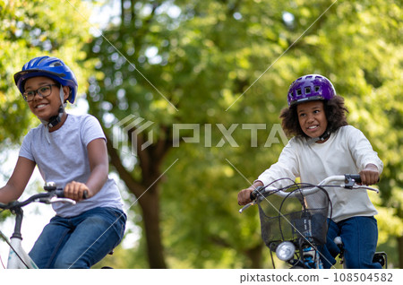 Cute african american kids riding bikes in the park 108504582