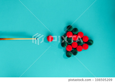 Creative Christmas tree made from red and green velvet Christmas balls and billiard cue on a turquoise background like pool table. Minimal Christmas or New Year concept. top view, copy space 108505209