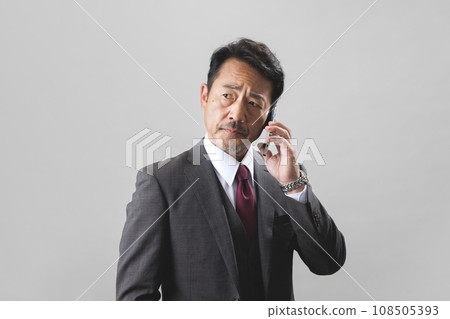 A middle-aged businessman wearing a suit 108505393