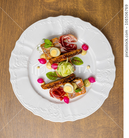 Gourmet dish, beautifully presented on a white plate 108506769
