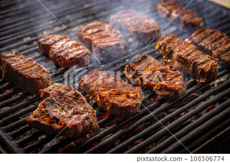 Steak sizzling on a grill Steak sizzling on a grill 108506774