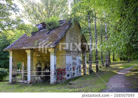 An old dilapidated building in a park covered with graffiti in summer An old dilapidated building in a park covered with graffiti in summer 108507095
