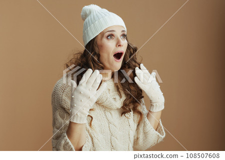 surprised stylish woman on beige background 108507608