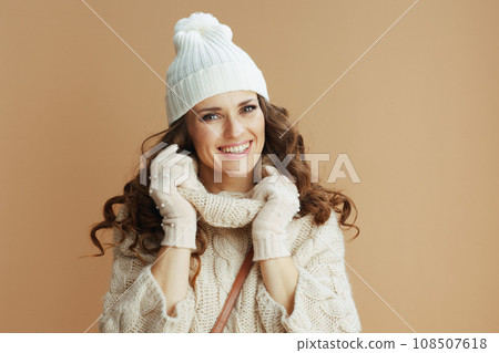 smiling elegant woman on beige background wrapped in collar smiling elegant woman on beige background wrapped in collar 108507618