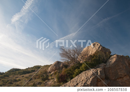 Rocks and vapor trails. Rocks and vapor trails. 108507838