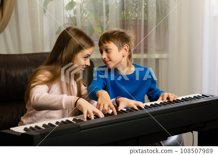 Siblings' Piano Time at Home 108507989