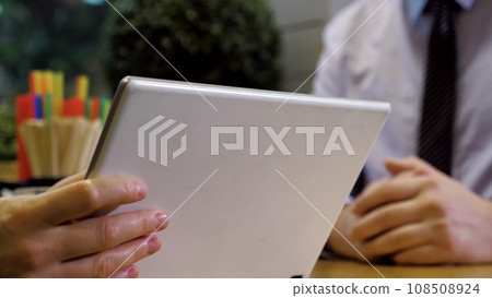 Businesspeople shake hands celebrating profitable deal online in cafe. Businesspeople with tablet handshake during work meeting in cafe. Partners discuss business via internet sitting in cafe 108508924