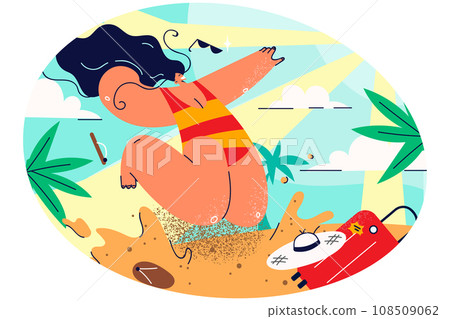 Smiling woman in biking jump on beach 108509062