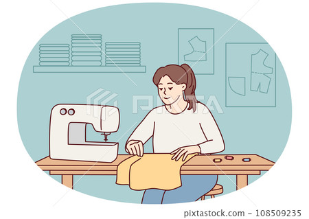 Female seamstress sewing on machine 108509235