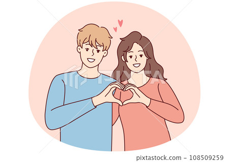 Smiling couple show heart hand gesture 108509259