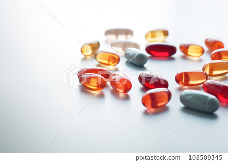 Pile of colorful medical pills on abstract background. Generative AI 108509345