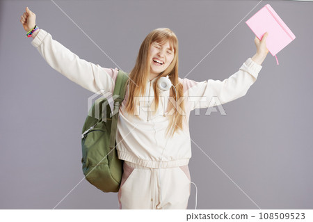 smiling modern teenage girl with raised arms rejoicing 108509523