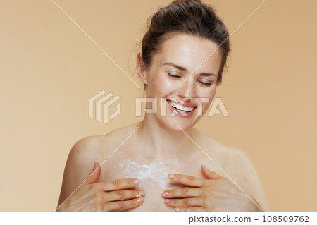 happy woman rubbing body cream happy woman rubbing body cream 108509762