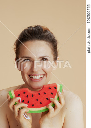 happy young 40 years old woman with watermelon shower sponge happy young 40 years old woman with watermelon shower sponge 108509763