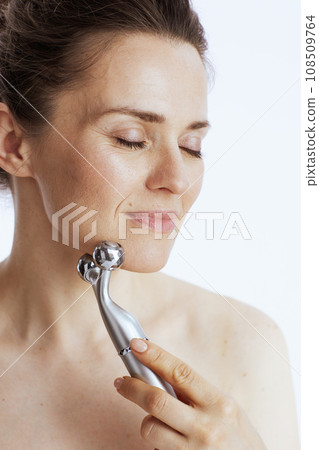 modern woman with massager on white modern woman with massager on white 108509764