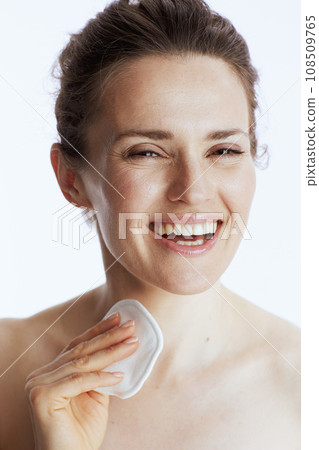 Portrait of smiling woman with cotton pad 108509765