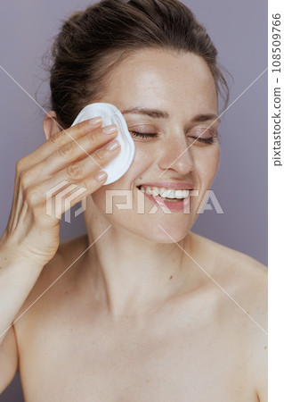 smiling modern woman with cotton pad smiling modern woman with cotton pad 108509766
