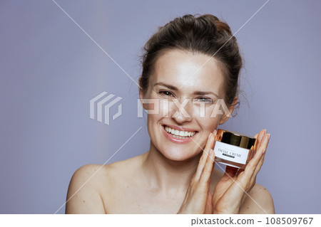 happy modern woman with cosmetic cream jar 108509767