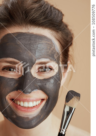 happy modern 40 years old woman with brush and facial mask 108509776