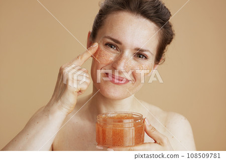 happy modern woman with face scrub happy modern woman with face scrub 108509781