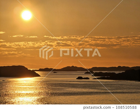 VIew on small islets in a north sea at sunset 108510588