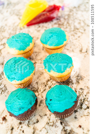 Using buttercream frosting, vanilla and chocolate cupcakes are intricately decorated to resemble various types of cactuses, creating a delightful and visually engaging dessert that showcases Using buttercream frosting, vanilla and chocolate cupcakes are intricately decorated to resemble various types of cactuses, creating a delightful and visually engaging dessert that showcases 108511595