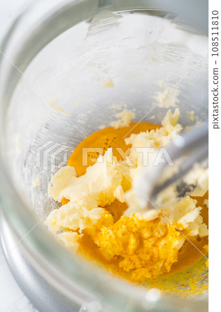 Lemon wedge cookies with lemon glaze. Mixing ingredients in kitchen mixer to bake lemon wedge cookies with lemon glaze. Lemon wedge cookies with lemon glaze. Mixing ingredients in kitchen mixer to bake lemon wedge cookies with lemon glaze. 108511810