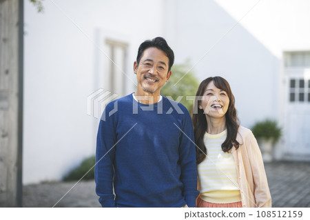 Portrait of a couple in their 50s smiling at the camera Portrait of a couple in their 50s smiling at the camera 108512159