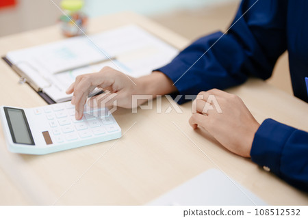 Young asian female work with financial papers at home count on calculator before paying taxes receipts online, planning budget glad to find chance for economy saving money, audit concepts 108512532