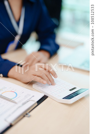 Young asian female work with financial papers at home count on calculator before paying taxes receipts online, planning budget glad to find chance for economy saving money, audit concepts 108512533