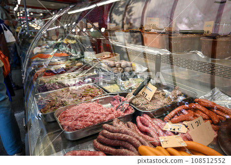 Paris, France. June 30 2022. At the beautiful Popincourt local market, a delicatessen counter with sausages, meat pie, preparations with meat and vegetables on display. Paris, France. June 30 2022. At the beautiful Popincourt local market, a delicatessen counter with sausages, meat pie, preparations with meat and vegetables on display. 108512552