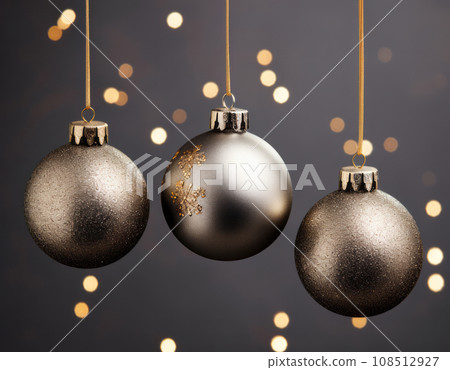 Three Christmas balls in gold and black colors on a black background Three Christmas balls in gold and black colors on a black background 108512927