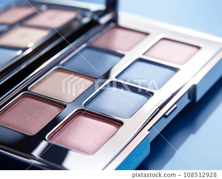 A close-up of pearlescent shimmery palette of blue eyeshadows for creating eye makeup. A close-up of pearlescent shimmery palette of blue eyeshadows for creating eye makeup. 108512928