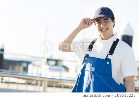Young fishermen standing at the fishing port 108513223