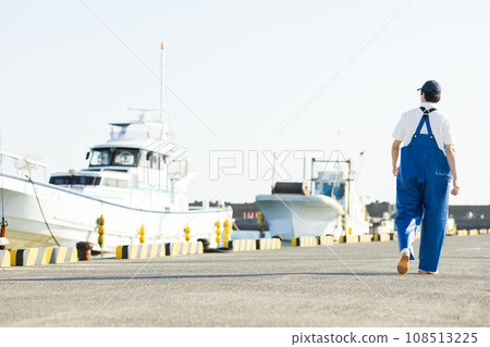 Young fishermen standing at the fishing port Young fishermen standing at the fishing port 108513225