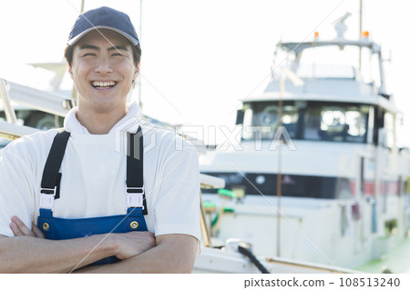 Young fishermen standing at the fishing port Young fishermen standing at the fishing port 108513240