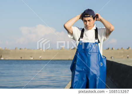 Young fishermen standing at the fishing port Young fishermen standing at the fishing port 108513267