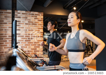 A woman using a treadmill at the gym A woman using a treadmill at the gym 108513883