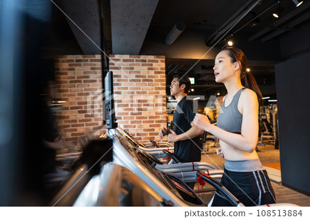 A woman using a treadmill at the gym A woman using a treadmill at the gym 108513884