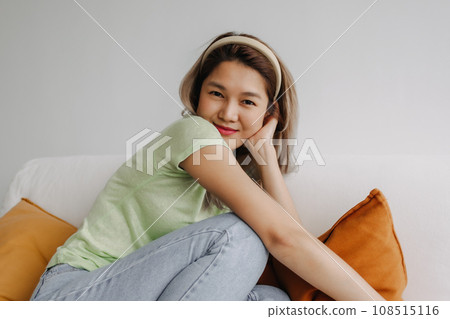 Happy and chill vibes asian woman alone in living room. Concept of love myself 108515116