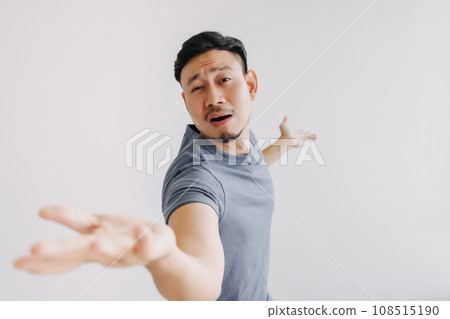 Funny and dramatic asian man is showing and offer hands stand isolated on white Funny and dramatic asian man is showing and offer hands stand isolated on white 108515190