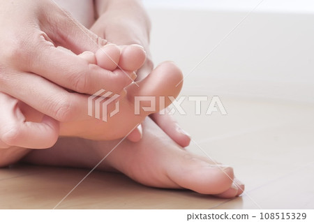 Young woman touching her toes Young woman touching her toes 108515329